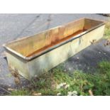 A plain rectangular galvanised garden trough with tubular rim. (74in x 20.5in x 12.75in)