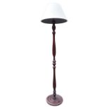 A mahogany standard lamp with baluster turned column on circular moulded base, mounted with