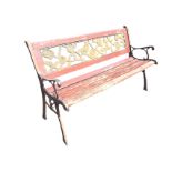 A rectangular 4ft cast iron bench, the back panel cast with pierced flowers and foliage above a