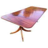 A Georgian style mahogany dining table, the rectangular top with ribbed edge and two leaves,