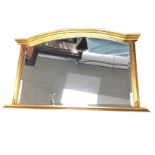 A reproduction gilt overmantle mirror with arched moulded frame to rectangular bevelled plate,
