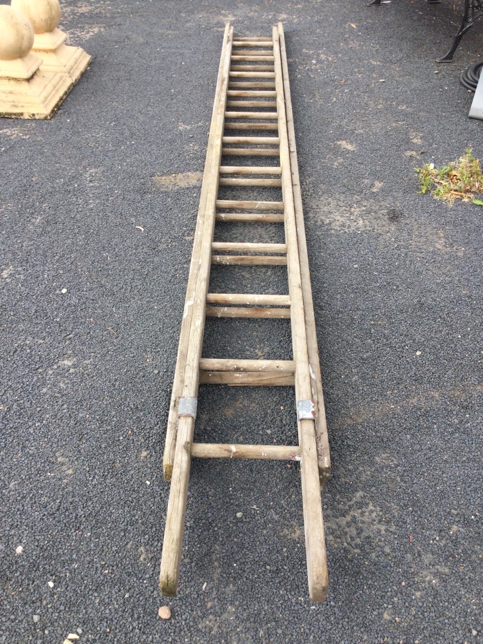 A two-piece pine extending ladder, the sections each with 12 turned hardwood rungs with - Image 2 of 3