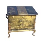 An embossed brass coal casket with embossed scene of viking ship to front panel, decorated with