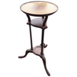 A Georgian style circular mahogany stand with tray top on three shaped supports above a ribbed