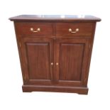 A reproduction mahogany side cabinet with moulded top above two frieze drawers mounted with brass