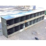 A long galvanised metal rack with eighteen pigeonholes with lips to fronts. (90.25in x 12.5in x