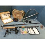 A quantity of fishing tackle including a Jarvis Walker 8ft spinning rod, a Shakespeare bag with