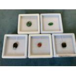 Five cased/boxed loose stones - a round chrysocolla - 3 carats, a dyed green oval jade - 1.4 carats,