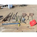 Miscellaneous garden hand tools including shovels, edging shears, rakes, a hoe, snow shovels,