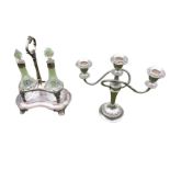 A silver plated candelabra with ribbed scrolled branches and three urn shaped candleholders on a