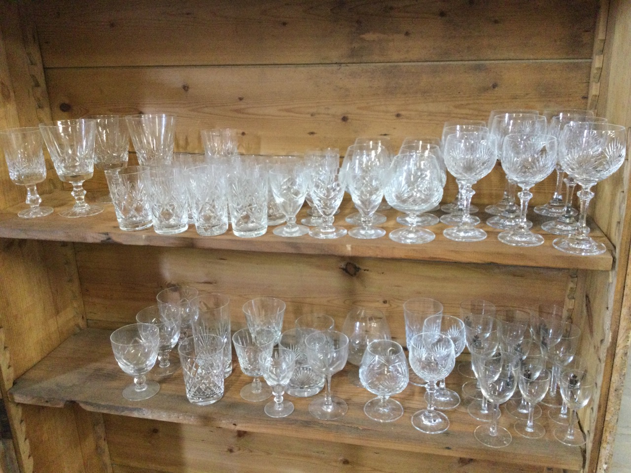 A large quantity of cut crystal drinking glasses, mainly in sets including brandy balloons, wine