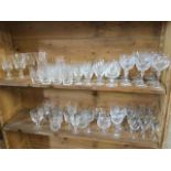 A large quantity of cut crystal drinking glasses, mainly in sets including brandy balloons, wine