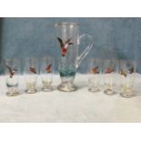 A handpainted glass cordial set with jug and six glasses having gilt rims, the birds including duck,