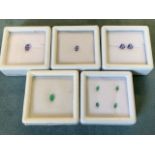 Five cased/boxed loose stones - two oval tanzanites - 0.5 carats and approx 0.2 carats, a pair of
