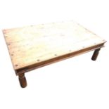 A rectangular hardwood coffee table, the moulded top with channelled apron having iron mounts,