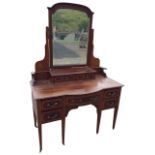 A nineteenth century mahogany satinwood crossbanded dressing table, the back with bevelled mirror in