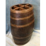 An oval oak stickstand formed from a teak barrel, with six divisions and internal zinc drip-tray,