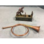 A copper French style hunting horn with brass mounts; and a reproduction cast iron novelty