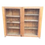A glazed pine cupboard with a pair of locking panelled doors enclosing adjustable shelves, having