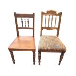 A late Victorian spindleback chair with carved arched crest to back, having sprung upholstered