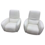 A pair of contemporary Italian leather armchairs with reclining backs and folding footrests,