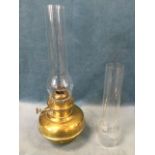 A Victorian brass oil lamp by Veritas with glass chimney; and a spare glass chimney. (19.5in) (2)