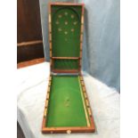 A Victorian mahogany cased bagatelle board by Gamage Ltd, the cleated box with brass mounts having