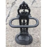 A Victorian style cast iron stickstand with pierced leaf cast column beneath scrolled pediment,