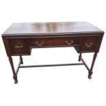 A mahogany dressing table with plate glass to rectangular caddy moulded top, the kneehole with