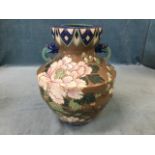 A large eastern stoneware vase with scraffito floral decoration of blossom foliage on brown