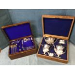 An oak cased Edwardian ribbed silver plated teaset, the married five pieces by Mappin & Webb,