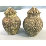 A pair of art nouveau pierced pomanders of urn shape with conical covers, the octagonal vessels with