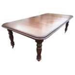 A Victorian style mahogany dining table, the rectangular moulded top with two leaves having