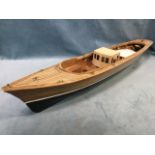 An electric powered model cruiser, the part finished wood boat with electrics, brass mounts, painted