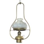 A Victorian brass hanging oil lamp converted to electricity, the frame supporting an embossed milk