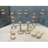 A pair of Edwardian silver plated candelabra each with three urn shaped candleholders, having ribbed