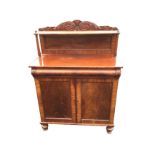 A Victorian mahogany chiffonier with scroll carved panelled back and shelf on tapering supports, the