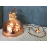 A contemporary Libra copper hanging light with long chain supporting inverted bowl shaped shade with