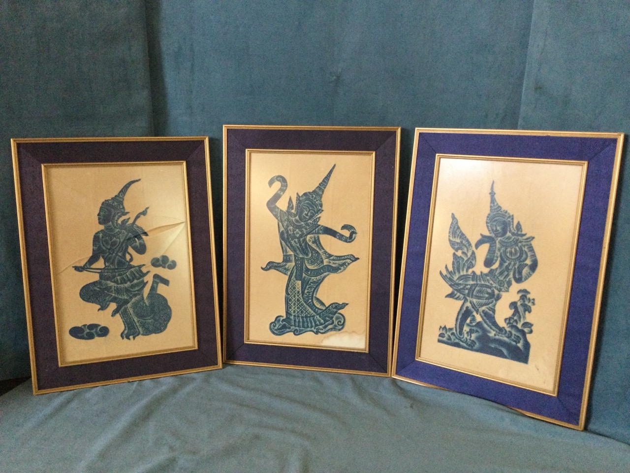 A set of three eastern embossed dancers/musician prints, the blue stained figures relief moulded and