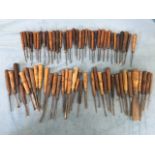 A collection of approx 70 antique woodcarving chisels with turned hardwood handles. (70)