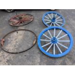 A pair of painted cartwheels with shaped spokes, iron rims and wide hubs - 36in dia; and another