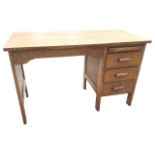 A C20th oak kneehole desk, the panelled open compartment with shaped apron flanked by a pedestal