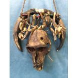 A Sarawak (Borneo) tribal necklace designed to ward off evil spirits, with monkey head, claws,