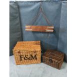 Two cane hampers with hinged lids; and a painted metal rectangular kitchen implement hanger on