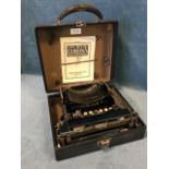 A cased Corona 3 portable folding typewriter in working order, with reproduction of original manual,