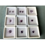 A collection of boxed amethysts, the range of purple stones of different cuts and sizes - two pairs,