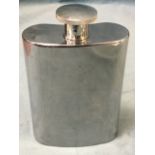 A giant novelty kidney shaped hip flask with screw stopper, named The Baby Growler Flask. (8.5in)