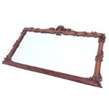 A carved mahogany overmantle mirror with foliate scrolled pierced crest, and acanthus leaf