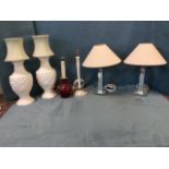 A pair of white painted chinoiserie blind fretwork cast vase tablelamps with figural panels framed