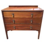 An Edwardian mahogany chest with three graduated long drawers mounted with brass drop handles, the